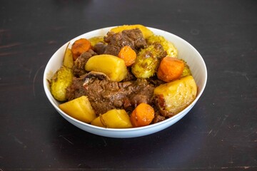 The most authentic and original Brazilian rustic pot roast, carne de panela,  with woody sauce and vegetables, served with farofa and salad