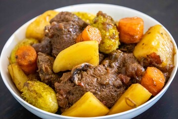 The most authentic and original Brazilian rustic pot roast, carne de panela,  with woody sauce and vegetables, served with farofa and salad