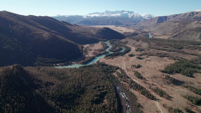 Panoramic aerial view of autumn Altai mountains,  Mount Belukha and Argut river captured near Beliashi village by a drone