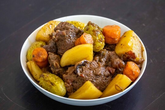 The most authentic and original Brazilian rustic pot roast, carne de panela,  with woody sauce and vegetables, served with farofa and salad