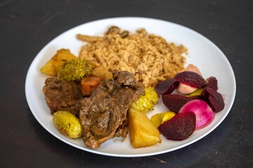 The most authentic and original Brazilian rustic pot roast, carne de panela,  with woody sauce and vegetables, served with farofa and salad