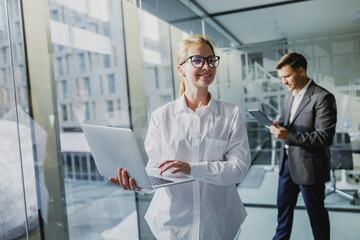 Fototapeta premium Professional individuals collaborating in a modern office setting while using technology