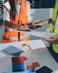 Closeup of team of industrial engineers meeting analyze machinery blueprints consult project on table in manufacturing factory. Working in manufacturing plant or production plant.