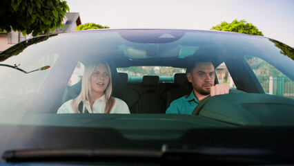 Driving Together Engaging in Deep Emotional Conversations while Traveling in a Car. A couple is deeply engaged in a serious discussion while driving through a beautiful and scenic neighborhood area