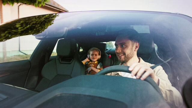 Family Road Trip Creating Joyful and Memorable Moments Together in the Car During Our Adventure. A joyful child and parent enjoy a memorable car ride together, capturing the essence of family bonding.