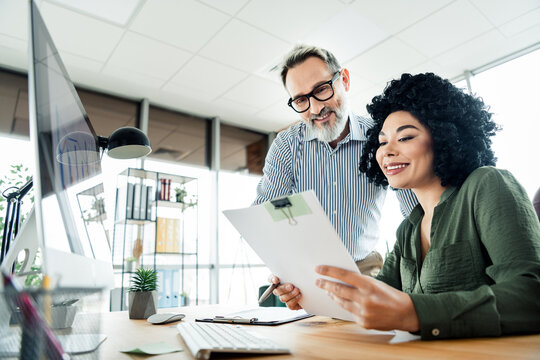Business professionals collaborating on a project in a modern office space, fostering teamwork and innovation for workplace success.