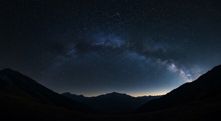 Stunning night sky astrophotography showcasing the vibrant Milky Way galaxy arching over a tranquil mountain valley silhouette