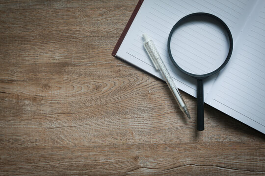 Office concept, business, notebook, pen and magnifying glass.