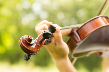 a young lady playing a violin outside © Blessings Captured