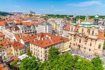 Obraz premium An aerial view north west past rooftops from the City Hall tower in the old town square in central Prague in springtime