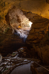 Vertical photo of light shining in the cave entrance of Carlsbad Caverns National Park.
