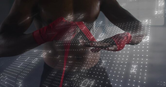 Wrapping shirtless boxer tightening red hand wraps inside gym room, with white binary code overlay - Powered by Adobe