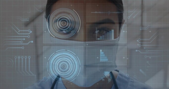 Analyzing doctor with stethoscope wearing surgical mask monitoring data panels in hallway
