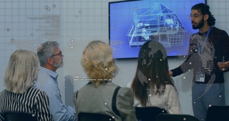Presenting Indian presenter gesturing at blueprint screen with map overlay in boardroom, copy space