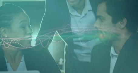 Collaborating professionals in suits reviewing results on laptop in conference room, with waveform