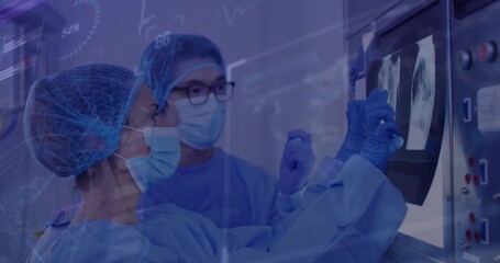 Reviewing radiologists in scrubs examining chest X-ray scans on panel in imaging room, with console