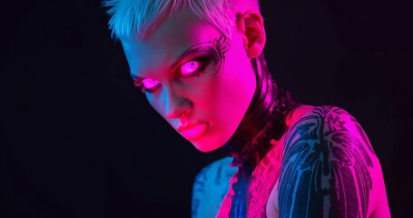 Turning tattooed model showing glowing white irises in studio under neon glow, futuristic portrait - Powered by Adobe