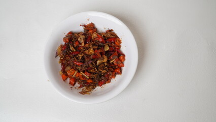 Sambal Embe, a typical Balinese chili sauce, Indonesia, served on a white plate with a white base (isolated white).