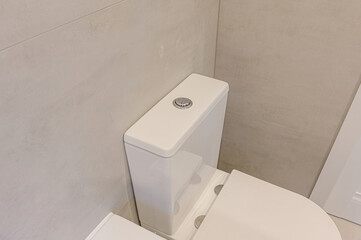 A close-up shows a white toilet against a tiled wall