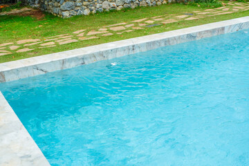 Empty swimming pool with sunbed and white umbrella in resort hotel for vacation leisure and white sand,resort neary sea and beach in summer.