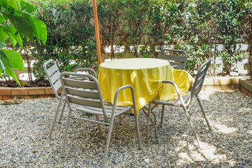 Colorful folding camping chair,wooden and chair set in garden on a sunny day,outdoor seating for restaurant or cafe.