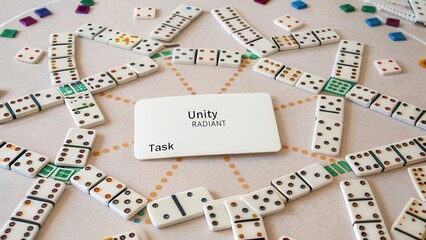 Naklejka premium Colorful Dominoes Arrangement with Unity and Task Cards in Focus