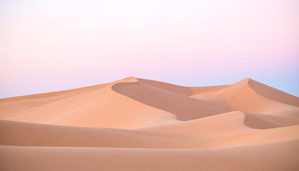 Serene desert landscape showcasing rolling golden sand dunes under a beautiful pastel pink and purple sky at dusk