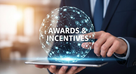 Person holding tablet displaying glowing sphere with "Awards & Incentives" text, symbolizing business rewards and motivation programs