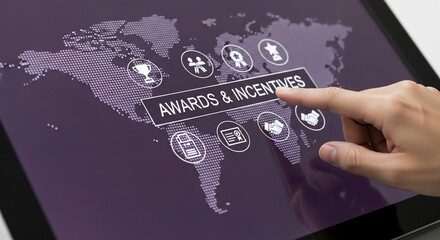 Hand interacts with tablet displaying "Awards & Incentives" on a world map background, showcasing global recognition and reward programs