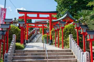 Inuyama, Aichi, Japan - July 22 2024 : The front entrance approach and stone steps of Sanko Inari Shrine.
