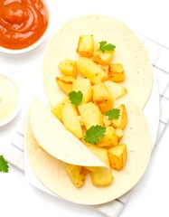 Two tortillas filled with roasted potatoes