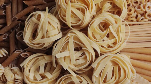 Pasta mix, different Italian tagliatelle fussili pasta packaging window, Fettuccine pasta, close up, not cooked