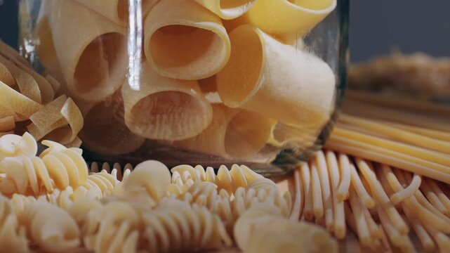 Pasta mix, different Italian tagliatelle fussili pasta packaging window, Fettuccine pasta, close up, not cooked