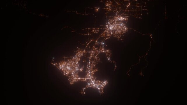 Darwin (Australia) top view at night. Aerial view on modern city with lights. Camera is flying above the city, moving backward. Vertical video. The north is on the left side