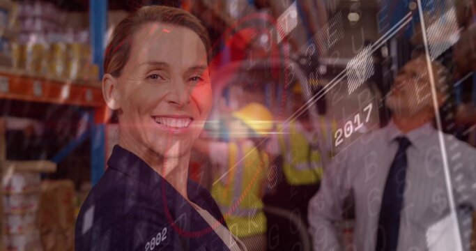 Smiling logistics manager in blazer monitoring overlays on boxes and racks in warehouse, copy space