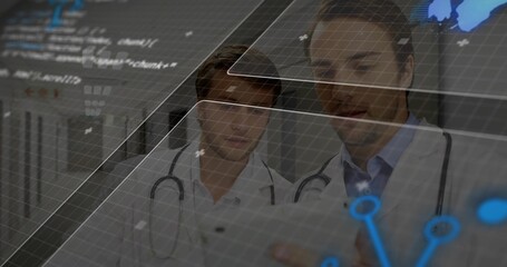 Viewing digital overlays, two male doctors examining tablet in medical corridor, with stethoscopes