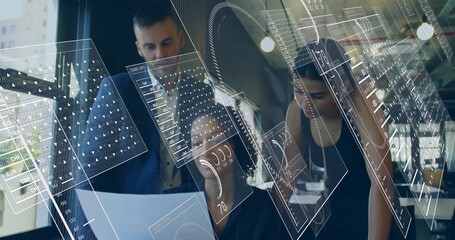 Collaborating team examining printed document on desk in office, coffee cup, glasses, AR overlays
