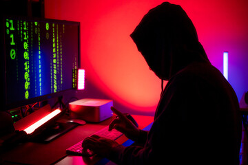 An expert hacker is decrypting data while hiding their face