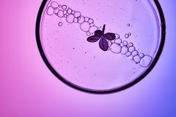 The texture of a cosmetic serum with a trail of bubbles on a purple background.