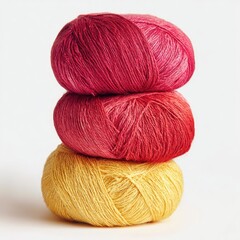Three balls of yarn stacked, ombre effect.  Red-pink to yellow