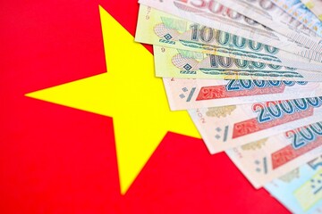 Vietnamese dong currency money bills lies on flag. The concept of business and investment