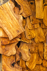 Olive wood chopping boards hanging in a store creating a beautiful pattern