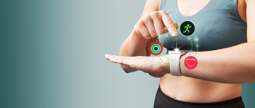 Caucasian sports woman checks her fitness statistics on smartwatch to monitor her training progress after working. Active and healthy lifestyle.  Copy space.