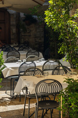 Outdoor Restaurant Tables and Chairs Waiting for Customers in Assisi, Italy
