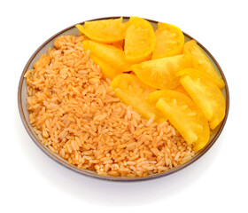 Cooked rice with sliced yellow tomatoes isolated on white background