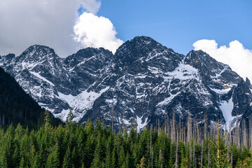 Fototapeta premium rocky high snow covered mountains with cloudy sky landscape