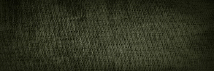 Black dark olive brown green khaki gray natural fabric cloth texture background. Close-up. Empty...