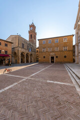 Naklejka premium Piazza Pio II featuring Palazzo Piccolomini and the Clock Tower in Pienza, Tuscany, Italy