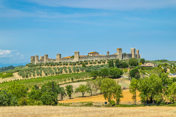 Obraz premium Monteriggioni medieval walls rising above Tuscan landscape in summer
