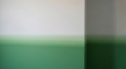 Blurry wall with a soft gradient of white and green.  A vertical grey line divides the colors